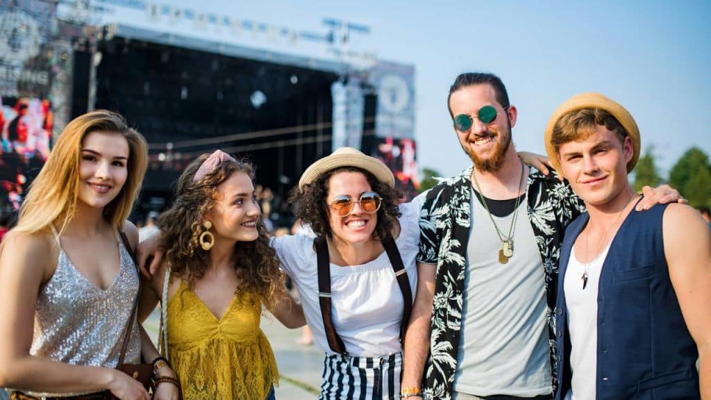 A group of friends posing at an outdoor event.