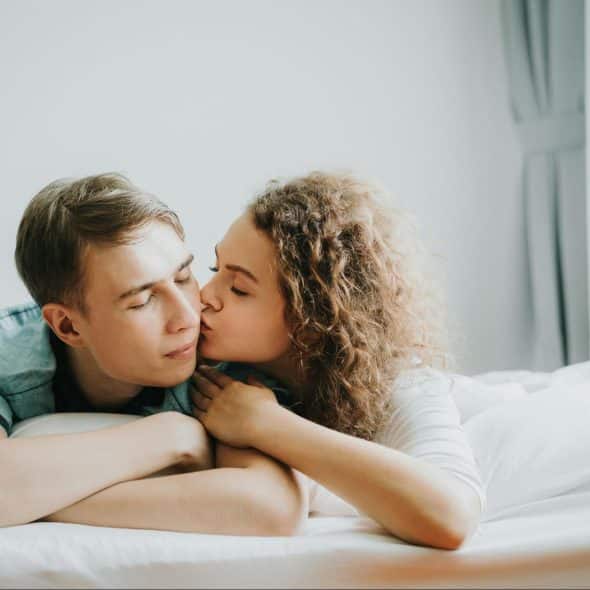A woman kissing a man’s cheek