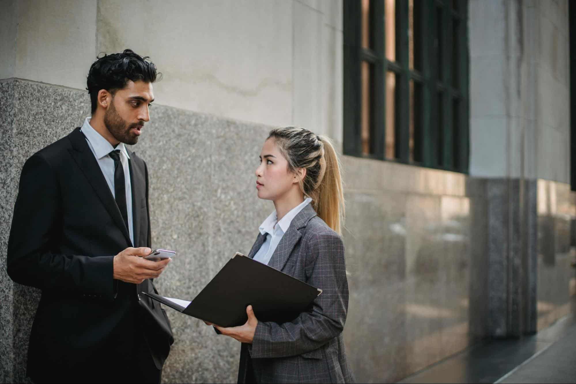 A man saying something to woman