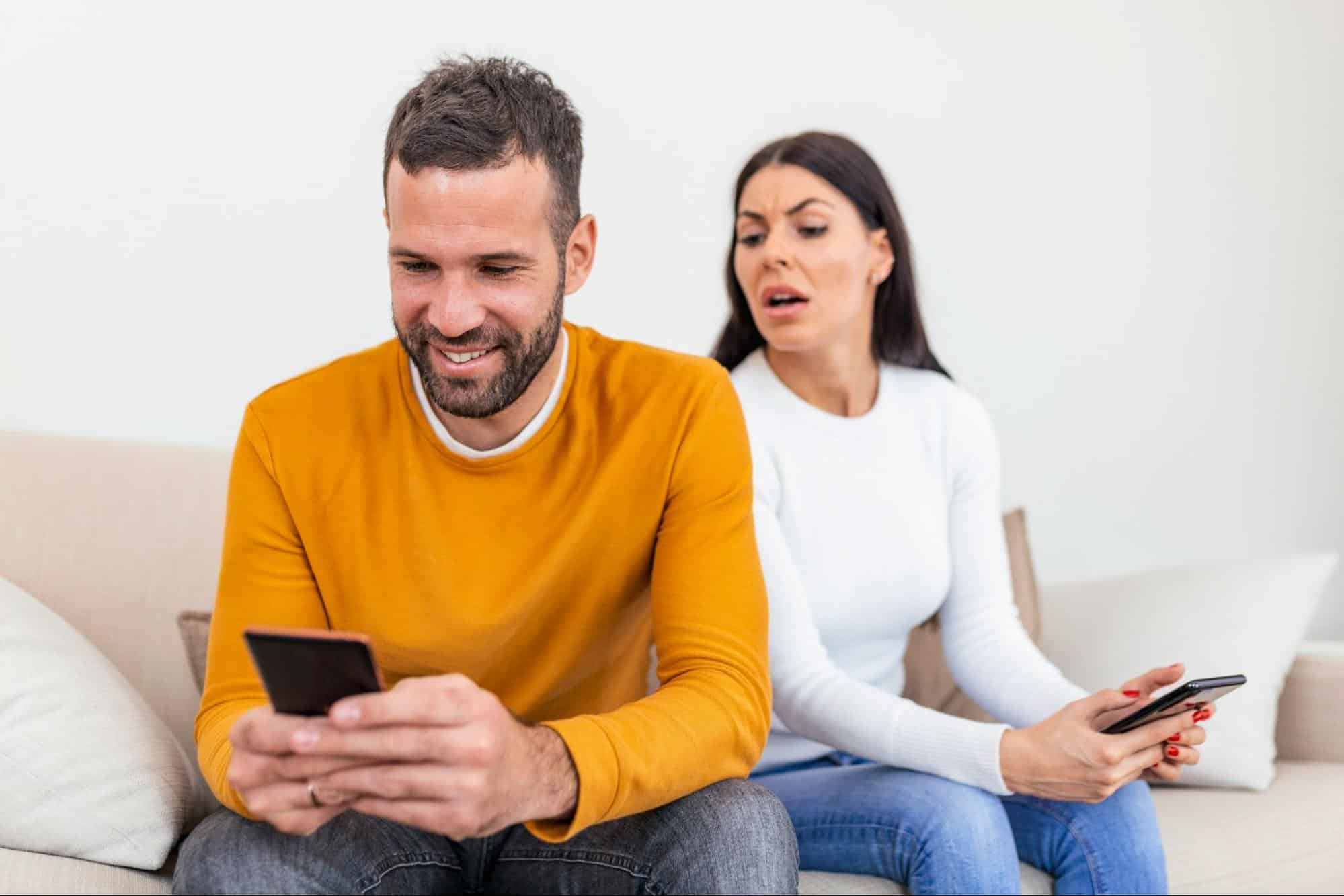 A woman looking at the man’s activities in phone