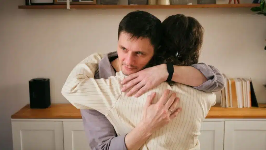 Man comforting his partner during an emotional moment