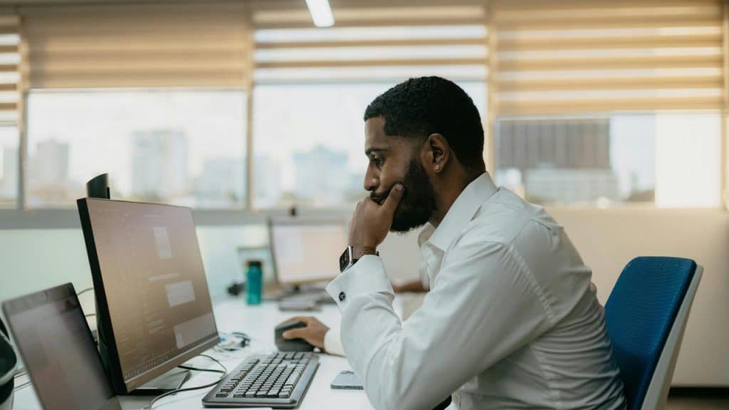 A man working at a computer in an office.
