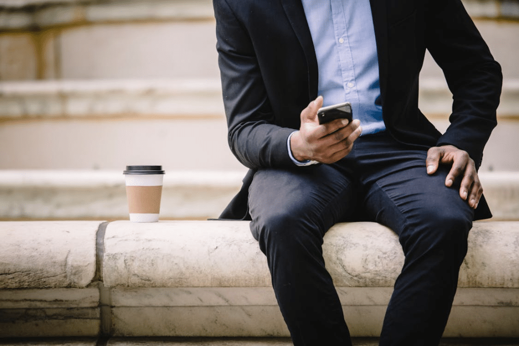A man sitting on a bench with a phone