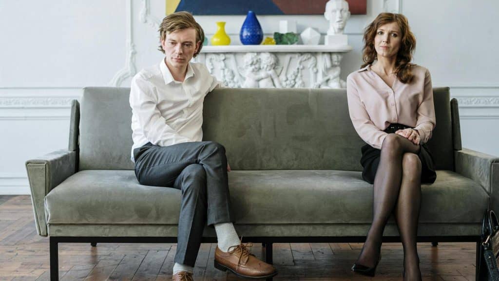 A couple sitting on the couch.
