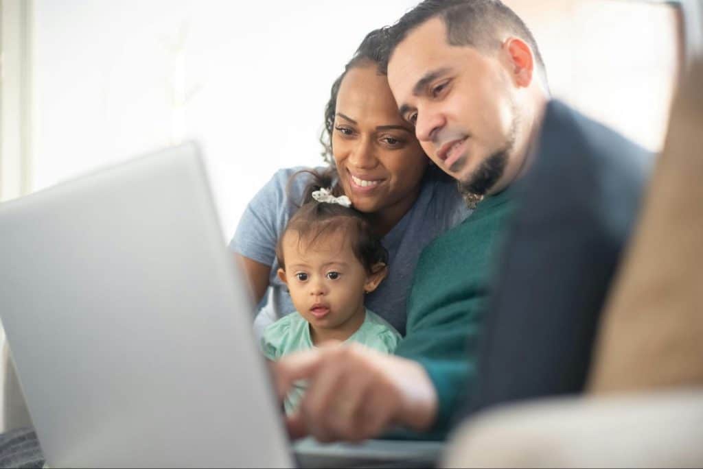 A man working while with his family