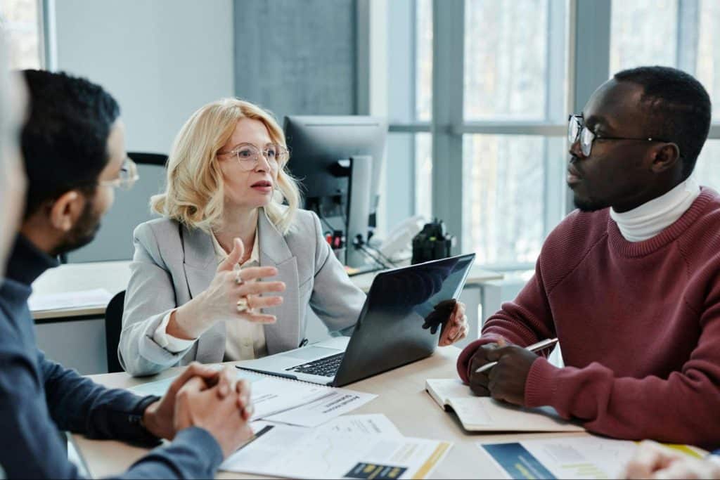 A man talking with his client and a woman beside him