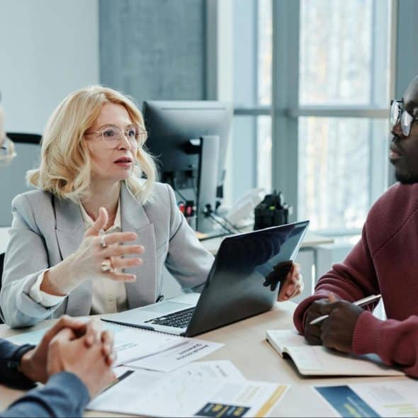 A man talking with his client and a woman beside him