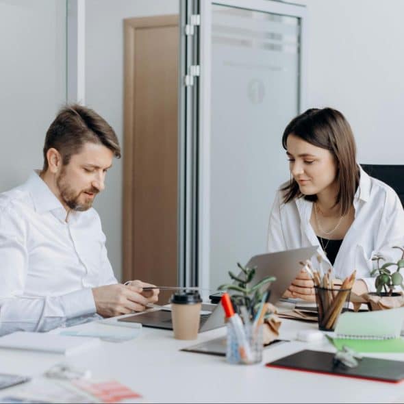 A man using a phone in front of his partner