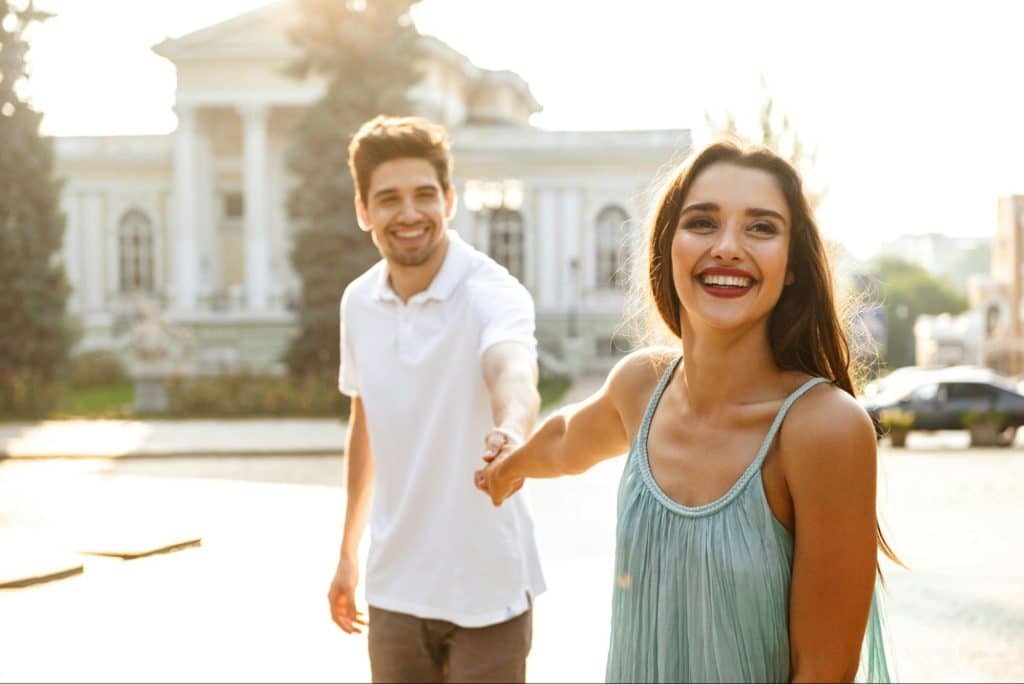 A woman holding the hand of a man