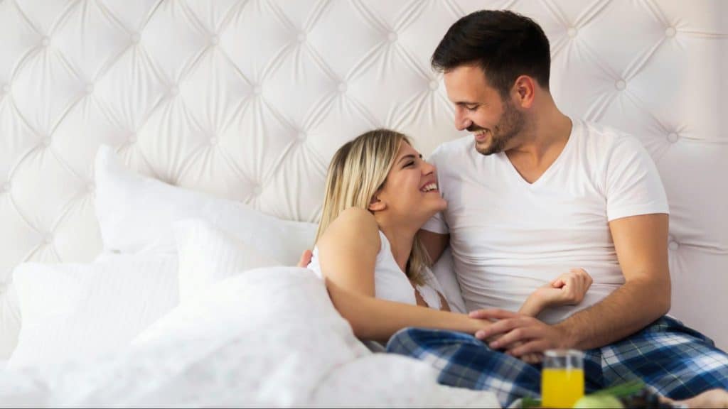A man and woman at the bed