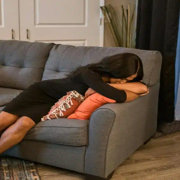 A woman looking sad at home