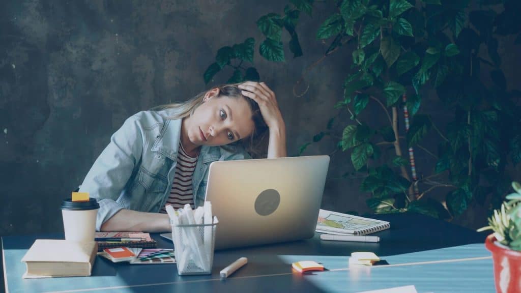 A woman looking stressed at work