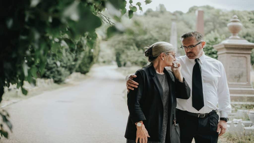A man comforting his grieving wife