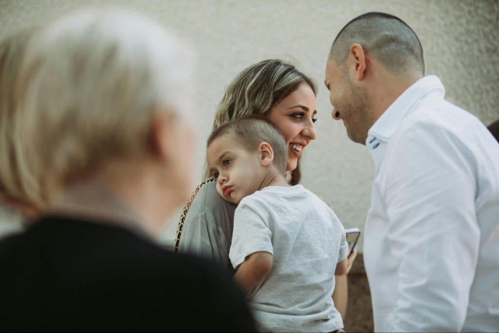 A couple with their child and a mother-in-law looking at them