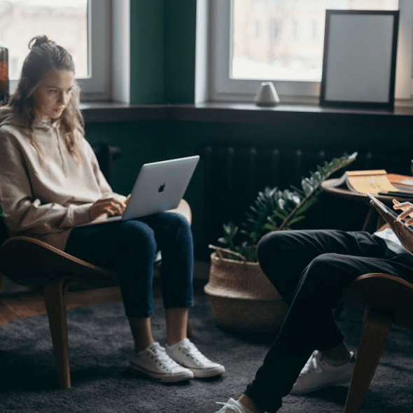 A man and woman using their gadgets.