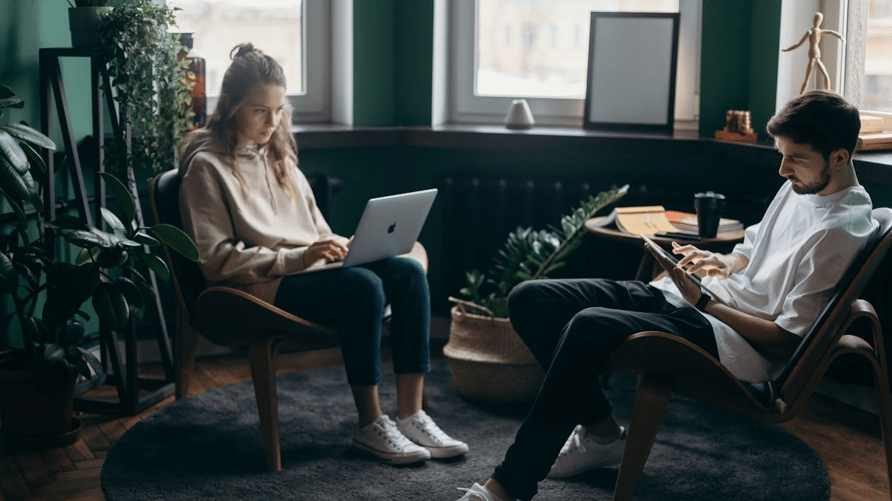 A man and woman using their gadgets.