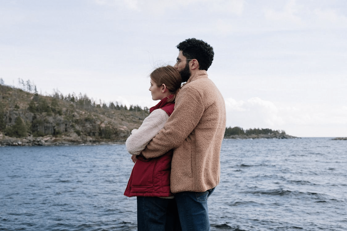 A man hugging the woman from behind