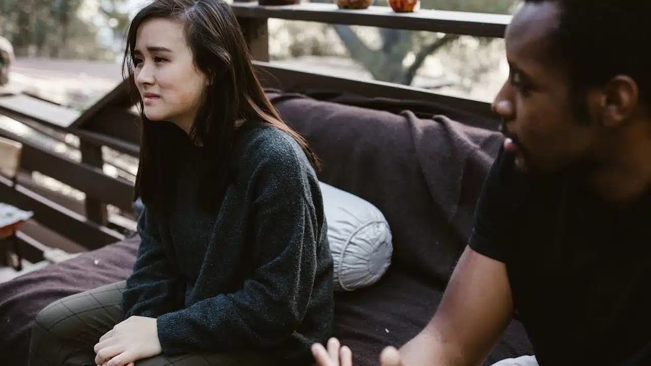 A couple talking sadly