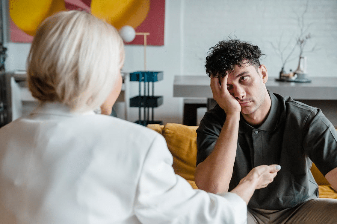 Man bored and unattentive talking to woman