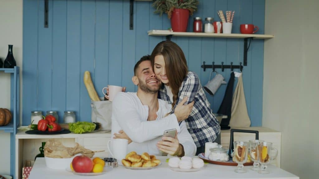 A couple hugging in the kitchen 