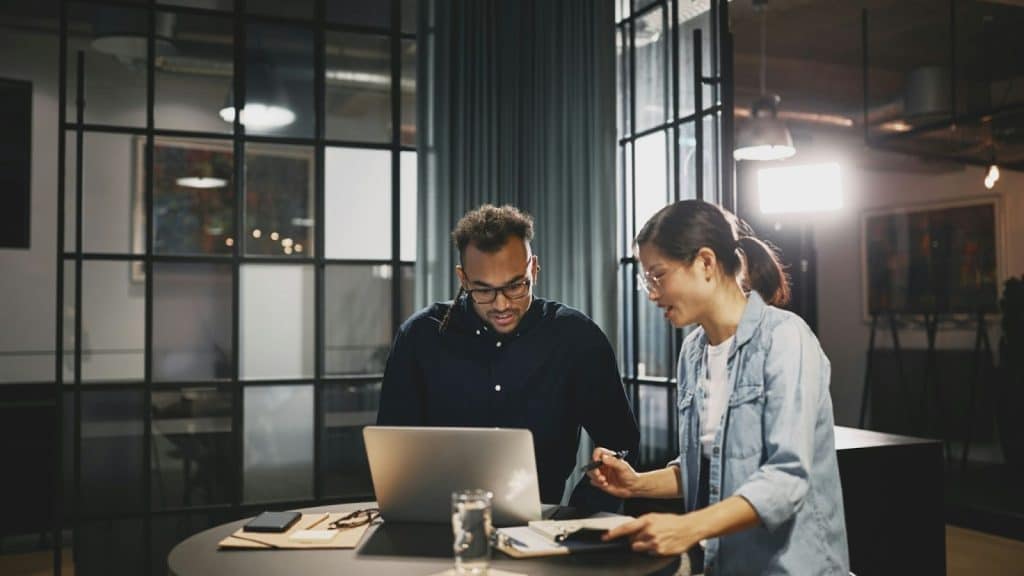 A man and woman having a conversation about work 