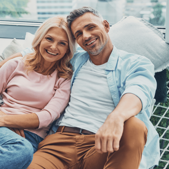 A mature couple smiling at the camera