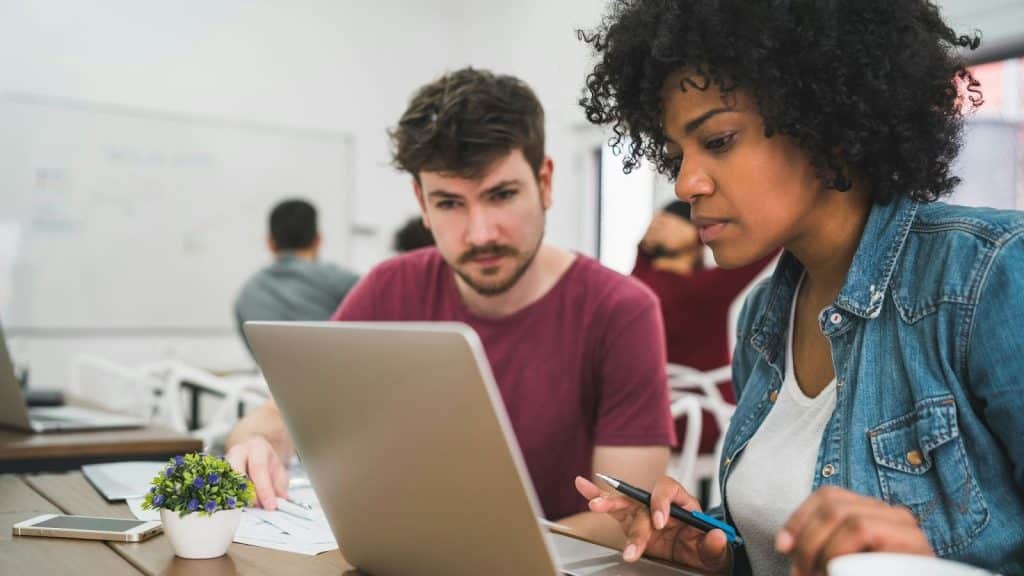 A man checking woman’s work