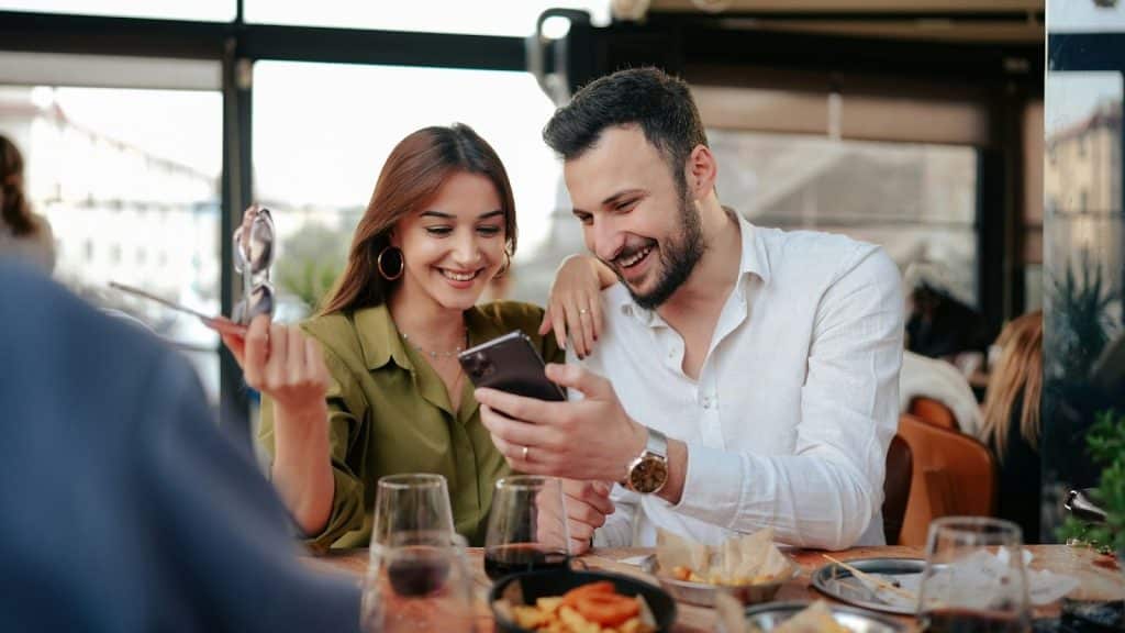 A man and woman eating outside