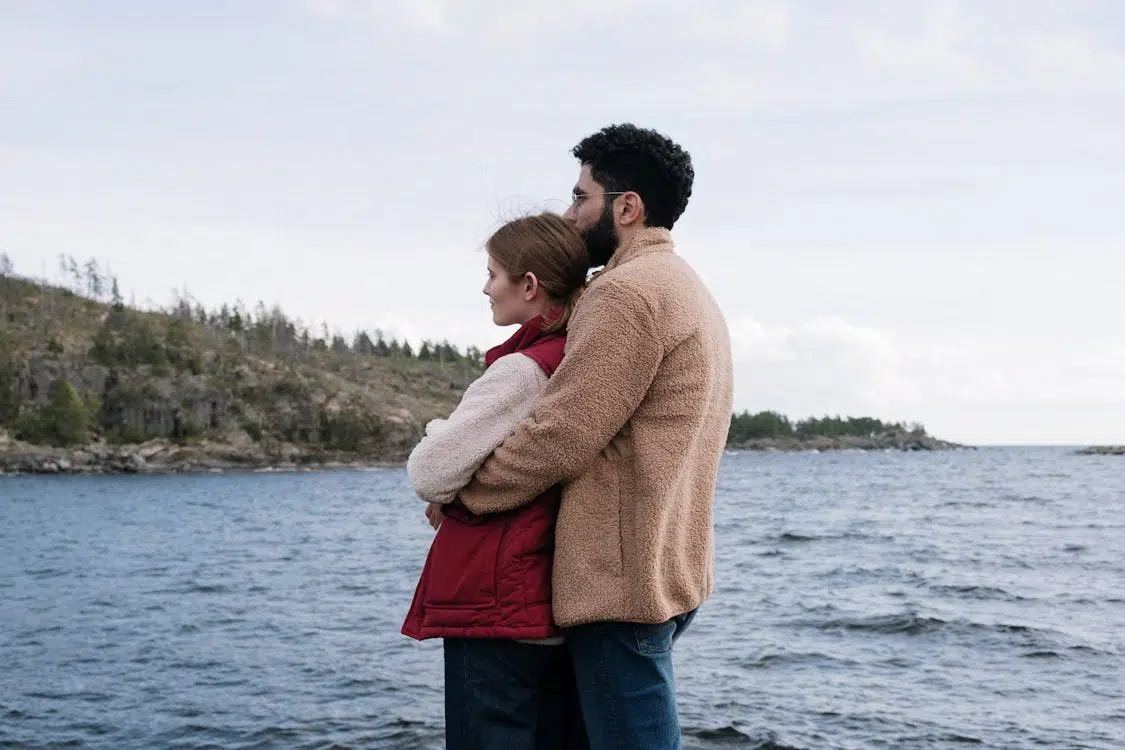 A man hugging the woman from behind
