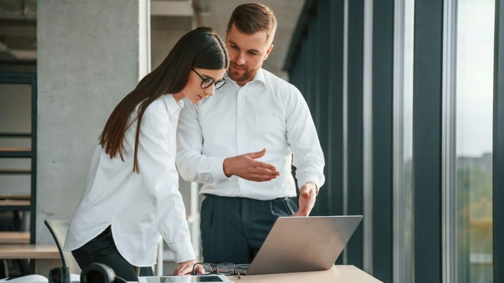 A woman getting help from a man