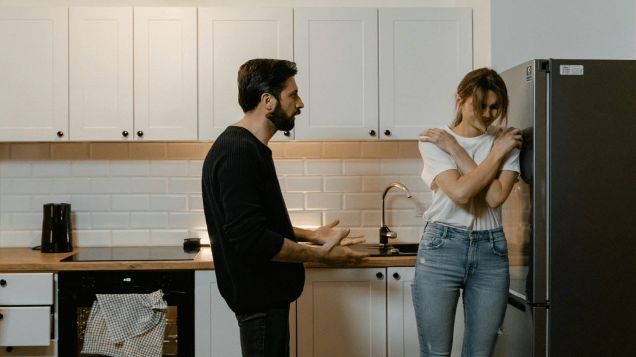 A couple having an argument in the kitchen
