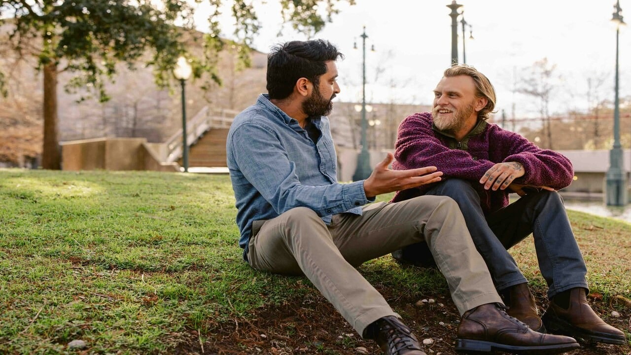 Male friends talking in the park