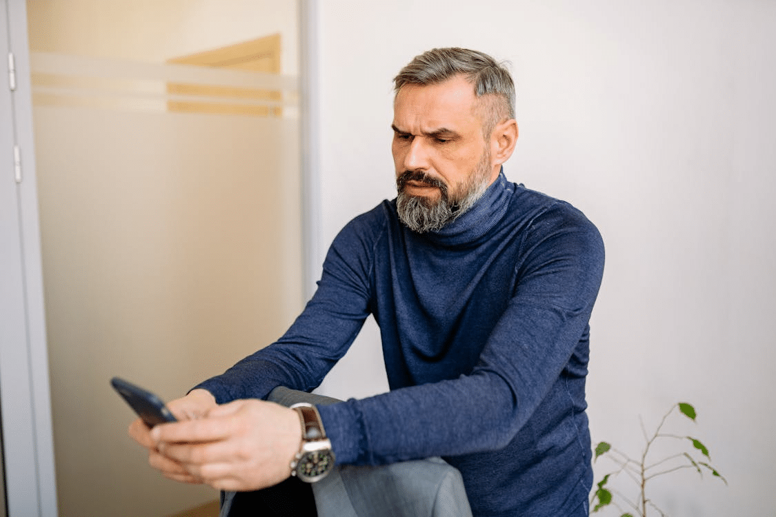 A man scrolling through his phone