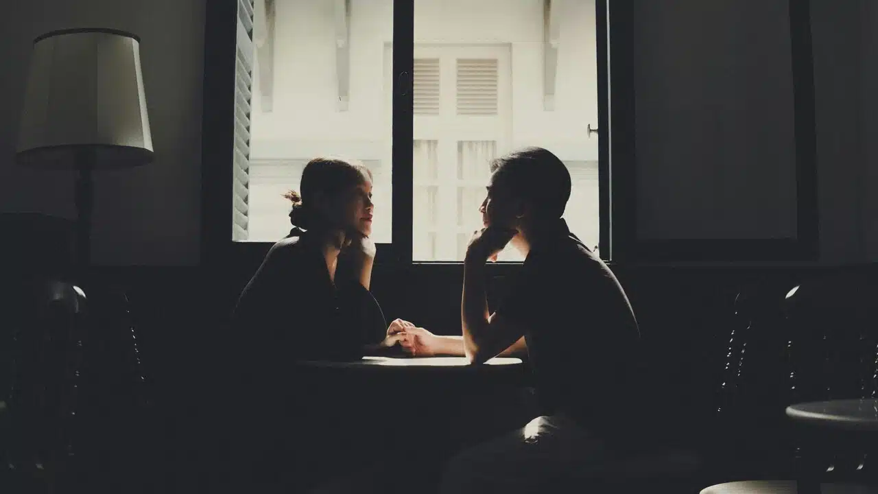 A couple talking at a cafe