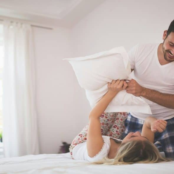 A couple having a pillow fight