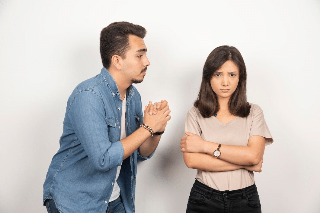 Upset man apologizing to woman