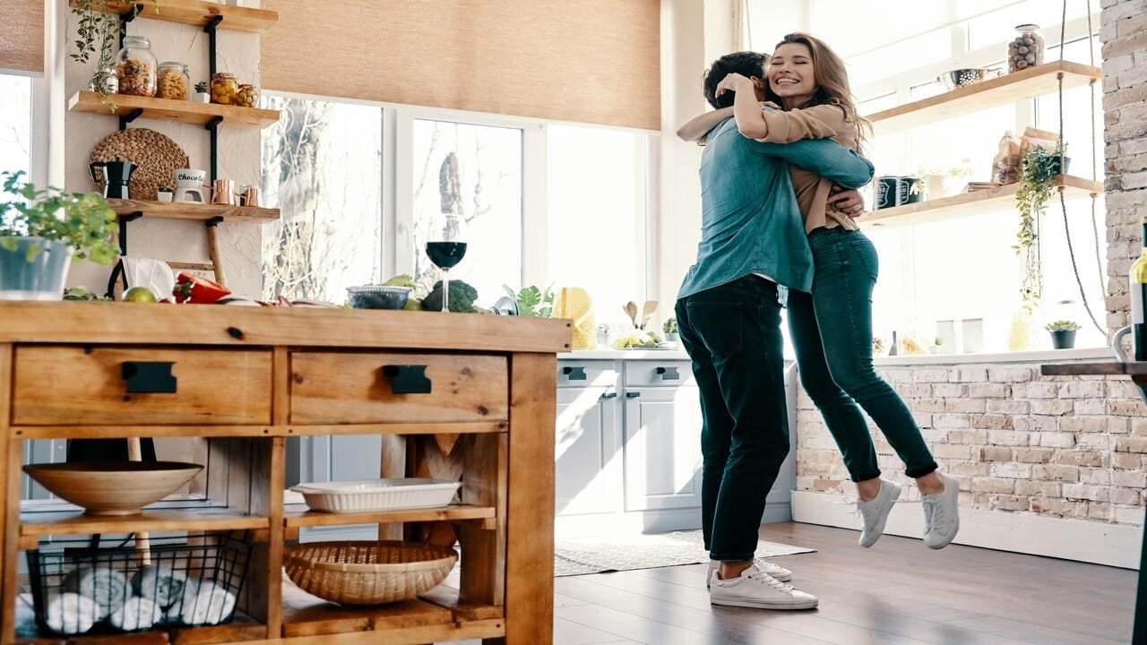 A couple hugging in the kitchen