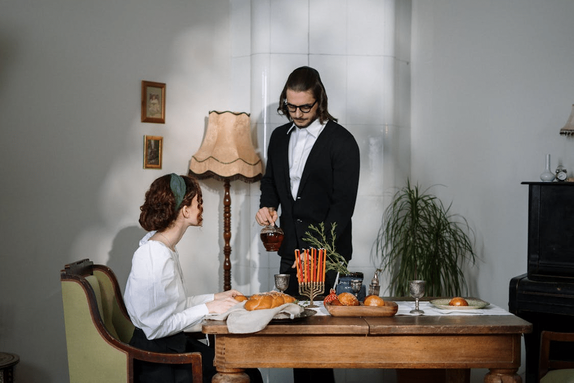 Man serving food to wife at dinner table