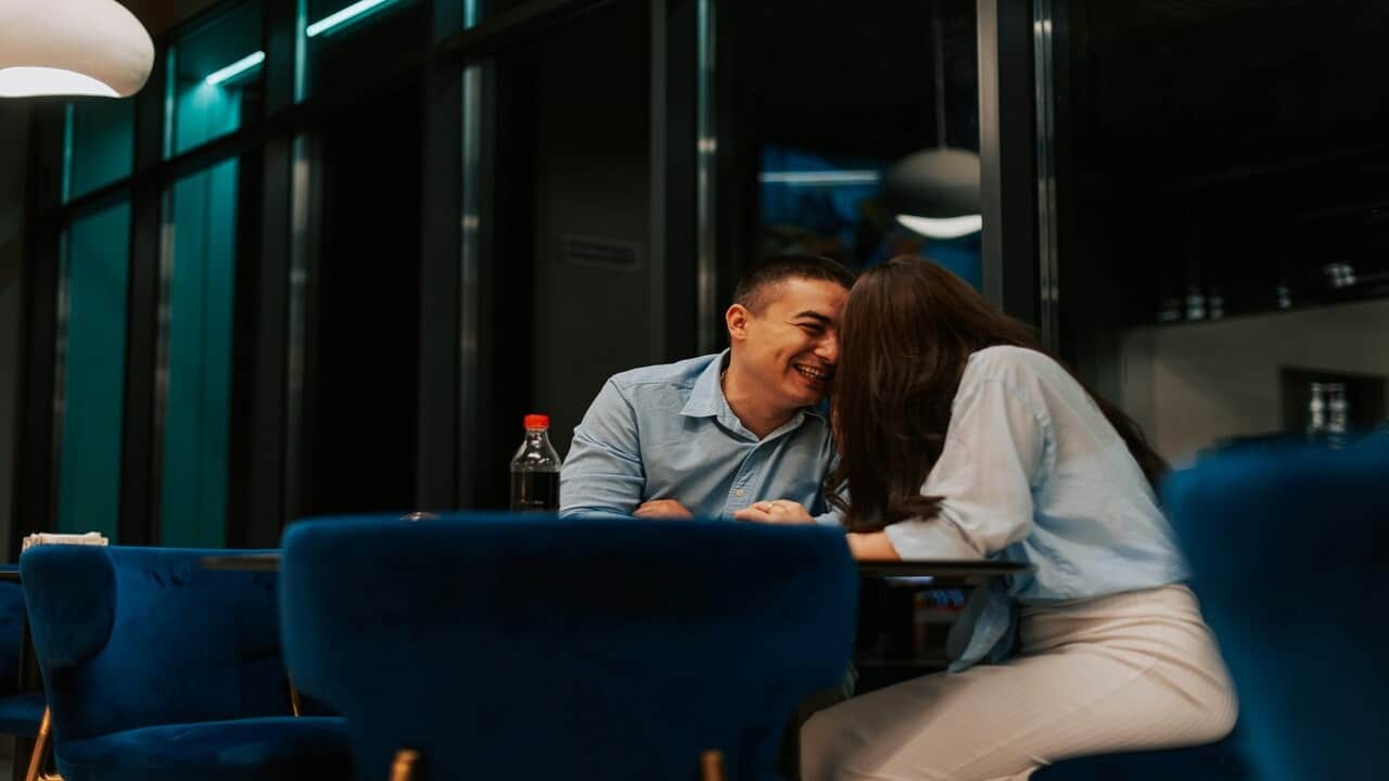 A couple laughing at a restaurant