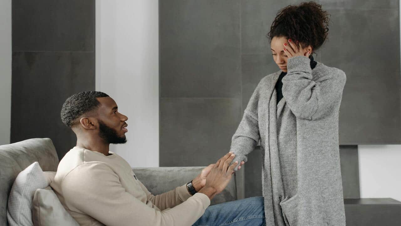 A man holding his tired wife’s hand