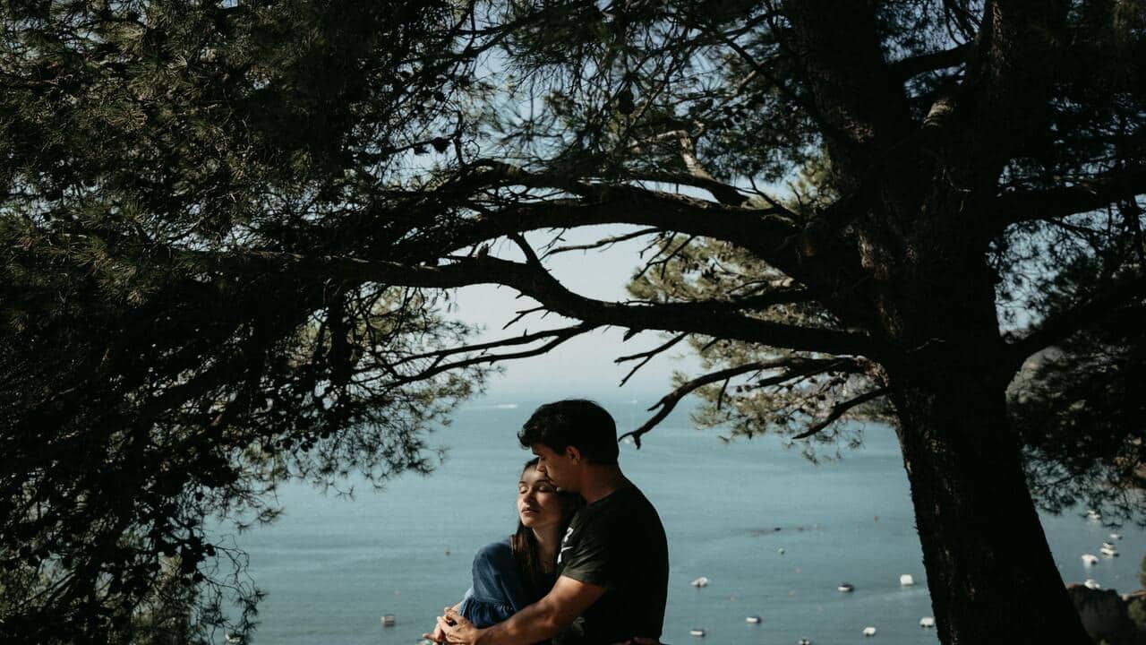 A couple hugging outdoors