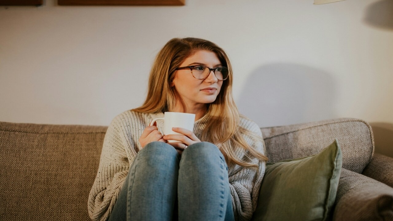 A woman thinking while having coffee
