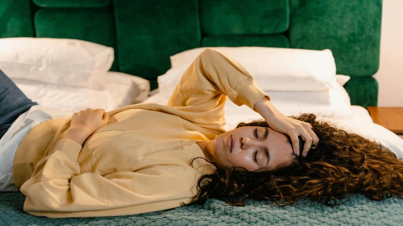 A woman looking tired at home
