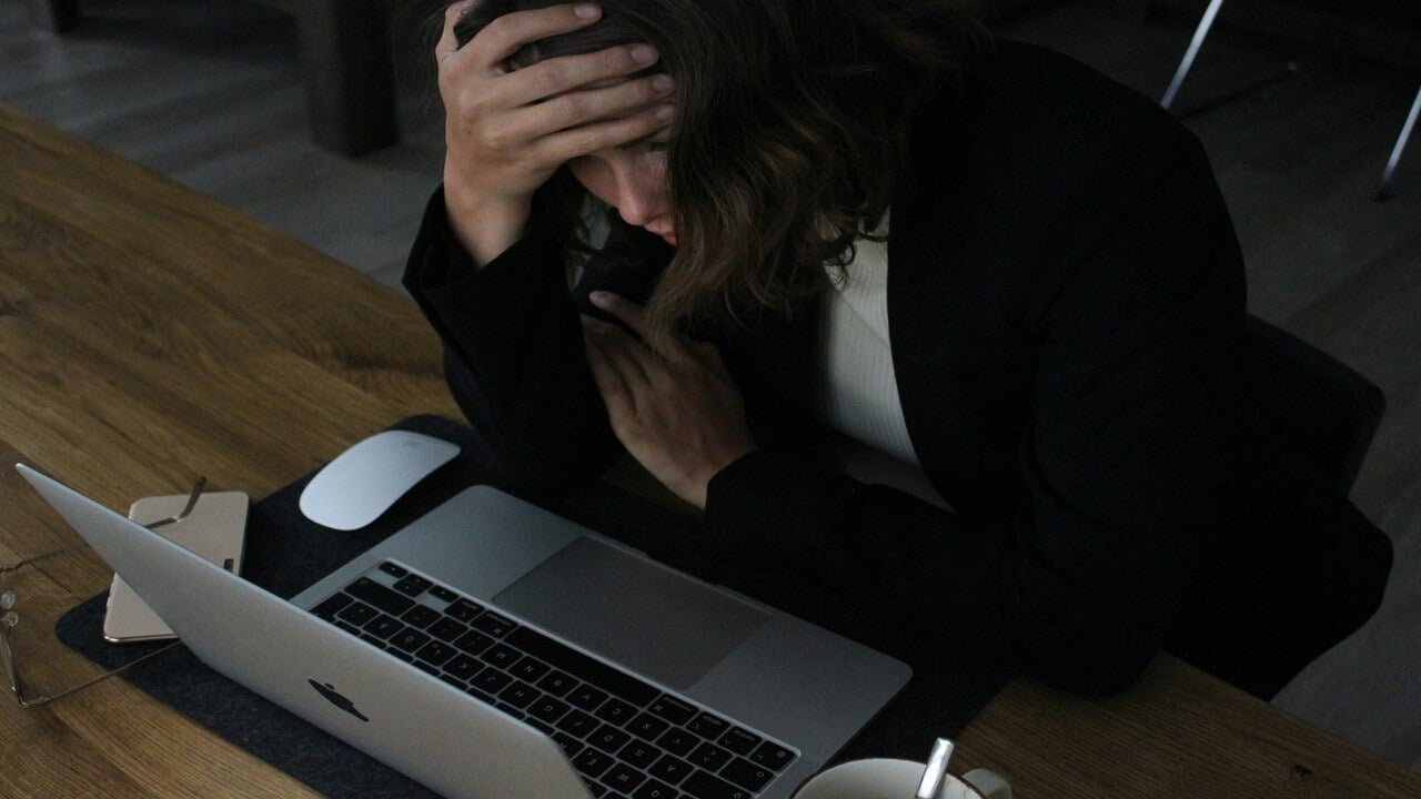 A woman looking stressed at work