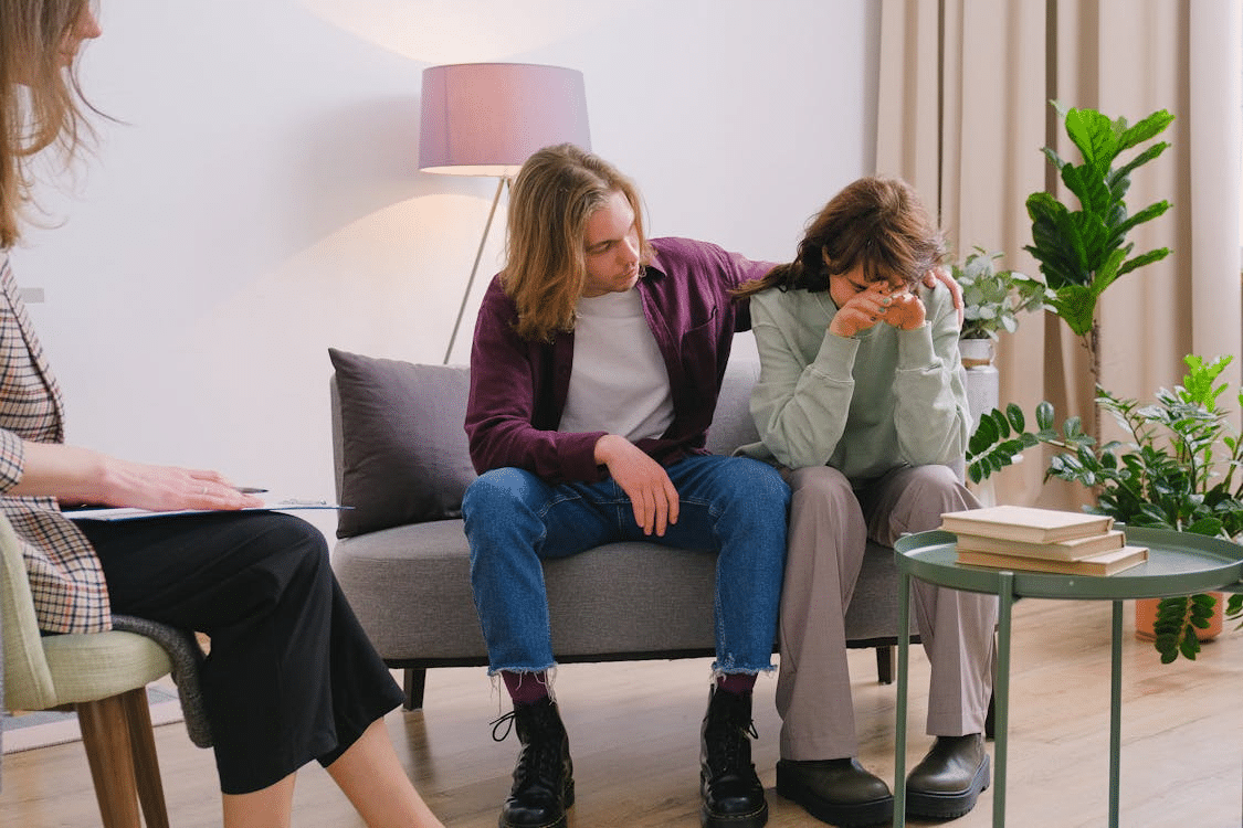 Couple discussing problems during session with psychologist
