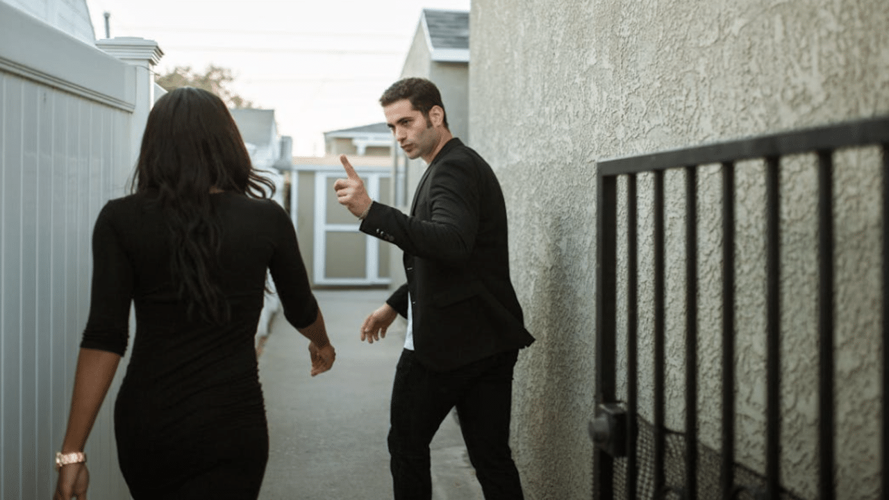 A couple arguing outside their home