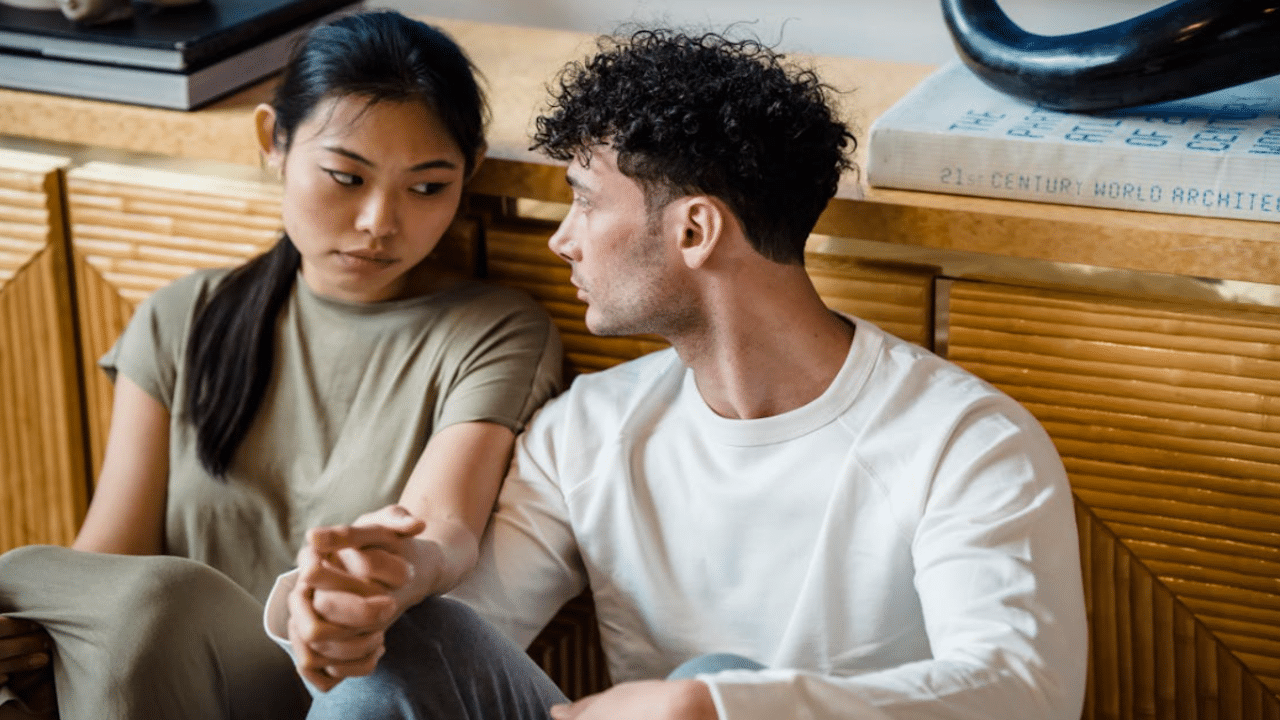 A couple talking on the floor