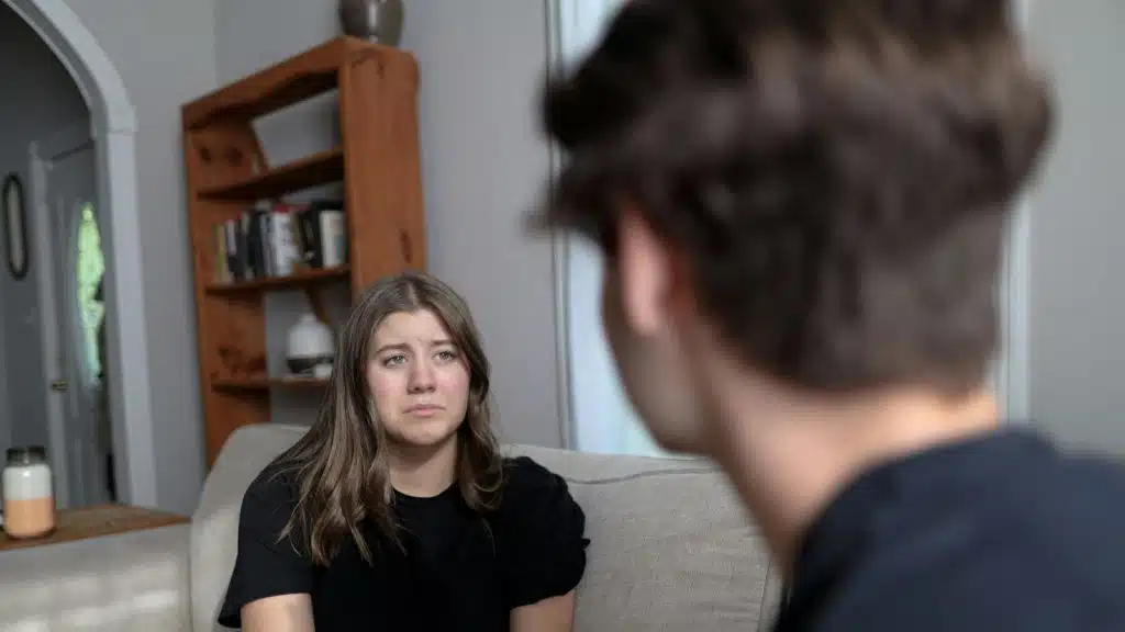 A sad woman talking to a man