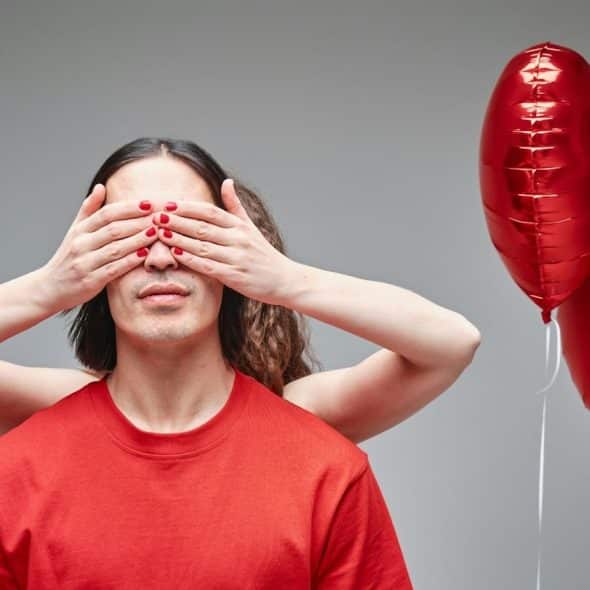 Woman covering a man’s eyes