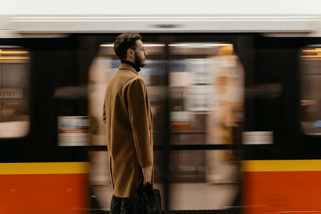 A man standing while waiting for a train